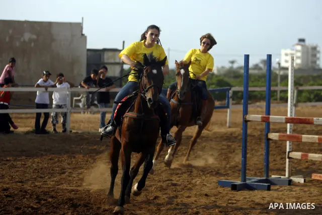 Palestinian ride horses during the "Jump Championship" race in Gaza City July 8, 2011.Photo by Ali Jadallah