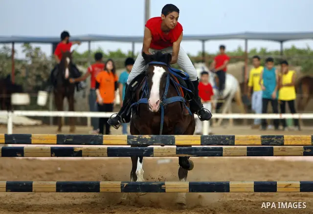 A Palestinian rides a horse during the "Jump Championship" race in Gaza City July 8, 2011. Photo by Ali Jadallah