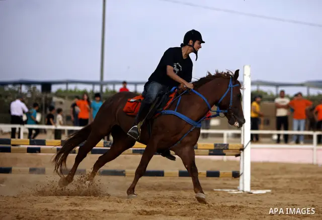 A Palestinian rides a horse during the "Jump Championship" race in Gaza City July 8, 2011. Photo by Ali Jadallah