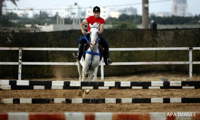A Palestinian rides a horse during the "Jump Championship" race in Gaza City July 8, 2011. Photo by Ali Jadallah