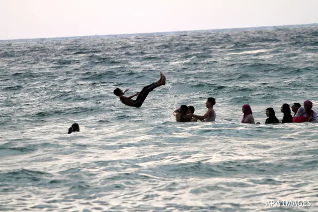 Palestinians enjoy swimming in the sea on Gaza's beach on on July 8, 2011. Reports state that during the summer the beach is a major venue for entertainment and leisure in the Gaza. Photo by Mohammed Asad