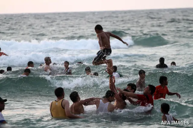 Palestinians enjoy swimming in the sea on Gaza's beach on on July 8, 2011. Reports state that during the summer the beach is a major venue for entertainment and leisure in the Gaza. Photo by Mohammed Asad