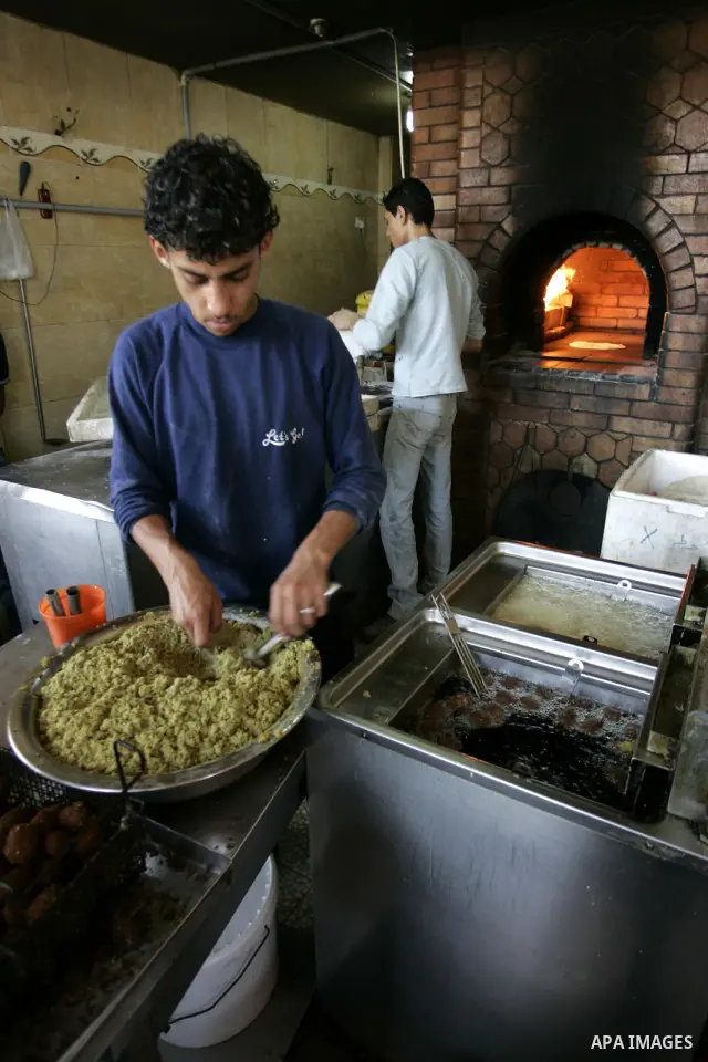 A Palestinian man prepares deep fried falafel at a restaurant in Rafah, southern Gaza Strip on July 9,2011. While the Palestinian President Mahmoud Abbas said that the financial crisis with the authority's real and diffi...