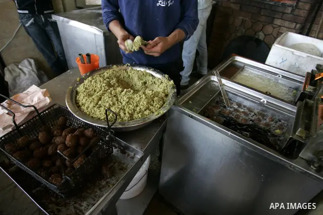 A Palestinian man prepares deep fried falafel at a restaurant in Rafah, southern Gaza Strip on July 9,2011. While the Palestinian President Mahmoud Abbas said that the financial crisis with the authority's real and diffi...