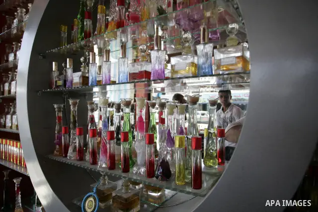 A Palestinian vendor sells perfumes at a shop in Rafah, southern Gaza Strip on July 9,2011. While the Palestinian President Mahmoud Abbas said that the financial crisis with the authority's real and difficult and we need...