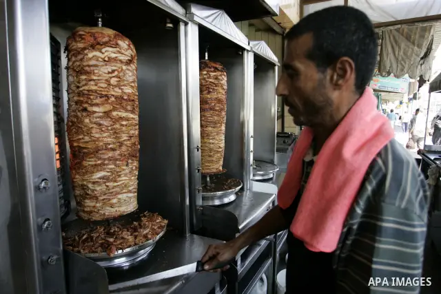 A Palestinian man prepares grilled meat at a restaurant in Rafah, southern Gaza Strip on July 9, 2011. While the Palestinian President Mahmoud Abbas said that the financial crisis with the authority's real and difficult...