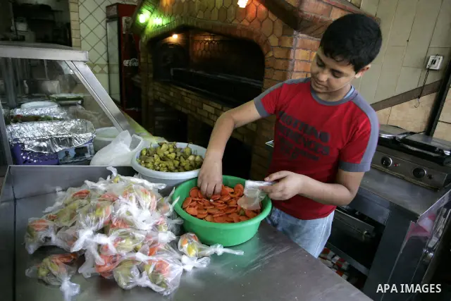 A Palestinian man prepares pickles at a restaurant in Rafah, southern Gaza Strip on July 9, 2011. While the Palestinian President Mahmoud Abbas said that the financial crisis with the authority's real and difficult and w...