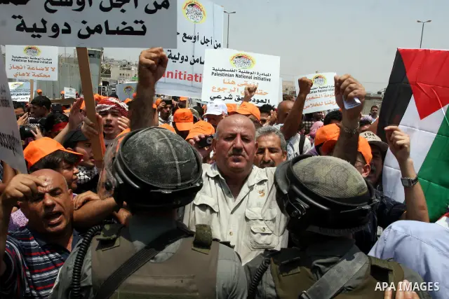 Israeli security forces scuffle with locally-based Palestinian demonstrators during clashes at the Qalandia checkpoint between the West Bank city of Ramallah and Jerusalem, Saturday, July 9, 2011. Israel's interior minis...