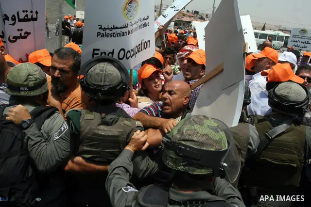 Israeli security forces push back locally-based Palestinian demonstrators during clashes at the Qalandia checkpoint between the West Bank city of Ramallah and Jerusalem, Saturday, July 9, 2011. Israel's interior ministry...