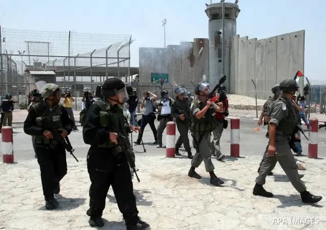 Israeli security forces take position during clashes with locally-based Palestinian demonstrators, not pictured, at the Qalandia checkpoint between the West Bank city of Ramallah and Jerusalem, Saturday, July 9, 2011. Is...
