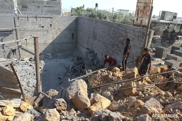 Palestinians inspect amid the ruins of a building bombed by Israeli aircraft in the east of Gaza City on July 10, 2011. Photo by Ashraf Amra
