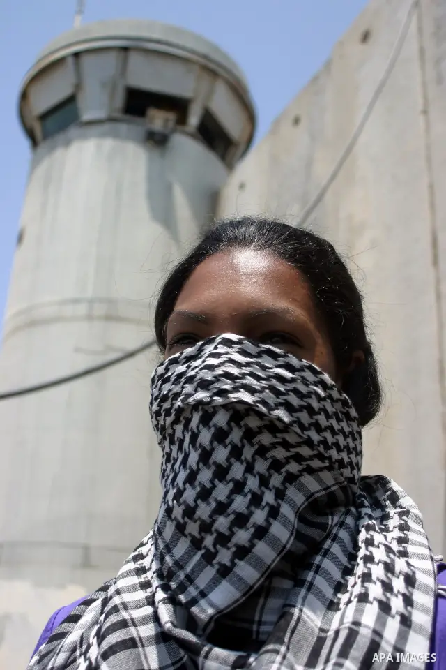 Palestinians and foreigners protest in front of a section of Israel's controversial separation barrier at the main entrance of the West Bank city of Bethlehem on July 10, 2011, marking the seventh anniversary of a ruling...