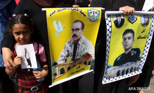 Relatives of Palestinian prisoners attend a march organized by the Red Cross calling Israel to allow residents of Gaza to visit their relatives imprisoned in Israel, on July 11, 2011 in Gaza City. Israel stopped allowing...