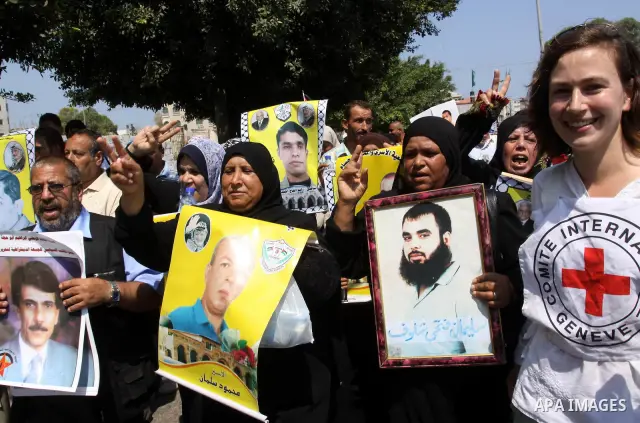 Relatives of Palestinian prisoners attend a march organized by the Red Cross calling Israel to allow residents of Gaza to visit their relatives imprisoned in Israel, on July 11, 2011 in Gaza City. Israel stopped allowing...
