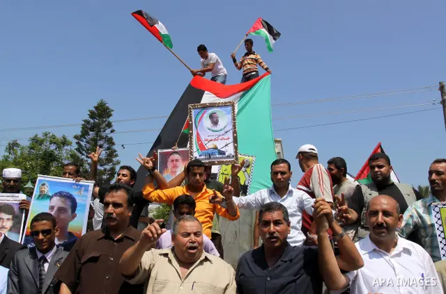 Relatives of Palestinian prisoners attend a march organized by the Red Cross calling Israel to allow residents of Gaza to visit their relatives imprisoned in Israel, on July 11, 2011 in Gaza City. Israel stopped allowing...