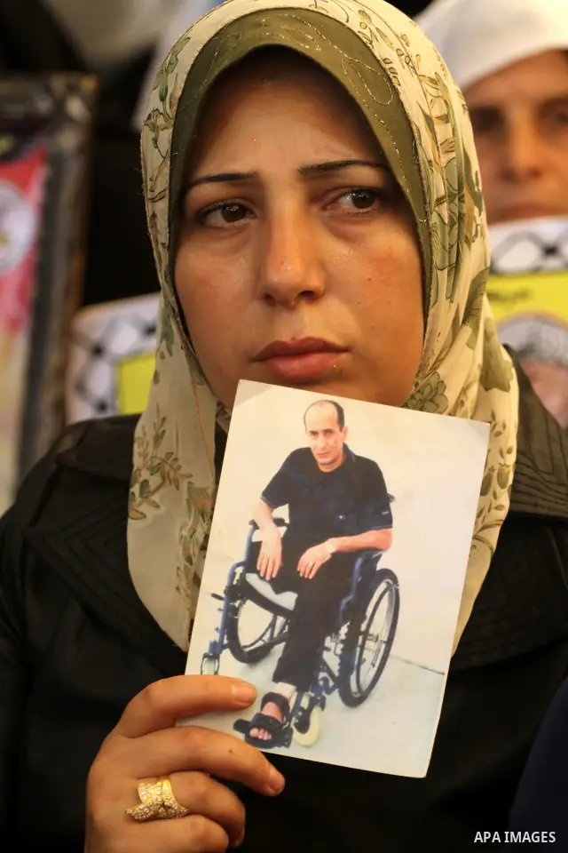 Relatives of Palestinian prisoners attend a march organized by the Red Cross calling Israel to allow residents of Gaza to visit their relatives imprisoned in Israel, on July 11, 2011 in Gaza City. Israel stopped allowing...