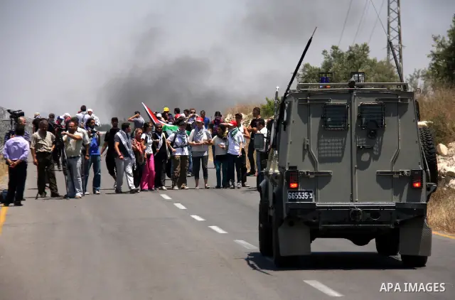 Palestinian and foreign protesters demonstrate against Israeli occupation and settlements on July 11, 2011in the village of Ezbet Tabeeb near the West Bank town of Qalqilya. Photo by Wagdi Eshtayah