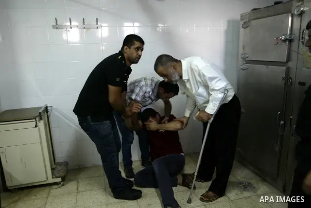 Friends and relatives of Palestinian Ibrahim Sarhan, killed by Israeli military, react in the morgue in the Rafidiya Hospital in the West Bank city of Nablus, Wednesday, July 13, 2011. Sarhan was killed Wednesday in an I...