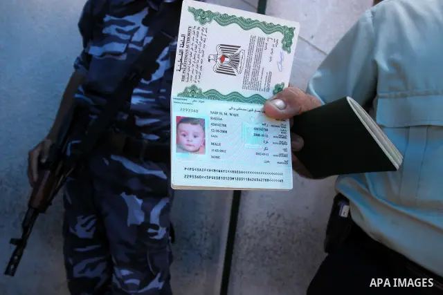 A Palestinian man displays his passport during registration his name with the Ministry of the Interior in the lists of travel in Gaza city on July 13, 2011. Where there are more than 20 thousand citizens need to travel a...