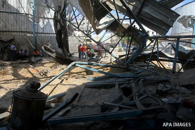 Palestinians inspect the site of an early morning Israeli airstrike in the al-Tuffah area, eastern Gaza City , which left one person wounded, on July 13, 2011, after Palestinians fired three rockets into southern Israel...