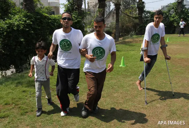 Palestinian members of the Olympic team for the disabled participate in training at Al-Gezira Club in Gaza city on July 13,2011. Palestinian Olympic team won Arab and international medals and have achieved excellent cent...