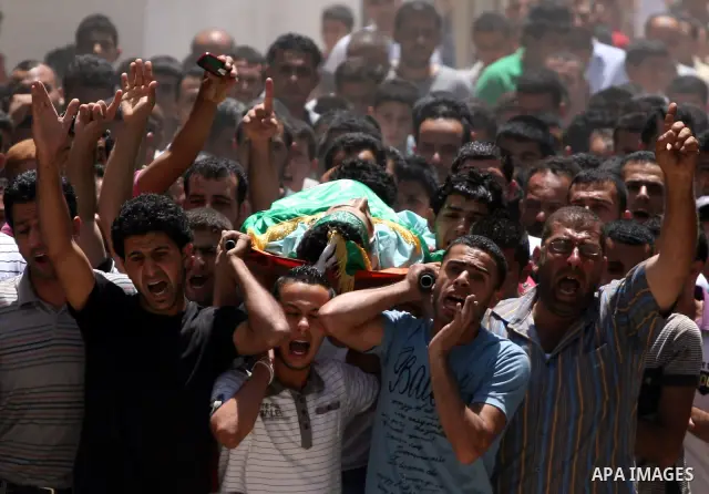 Palestinian mourners carry the body of Ibrahim Sarhan, killed by Israeli military, during his funeral in the West Bank refugee camp of El Fara, north of Nablus, Wednesday, July 13, 2011. Sarhan was killed Wednesday in an...