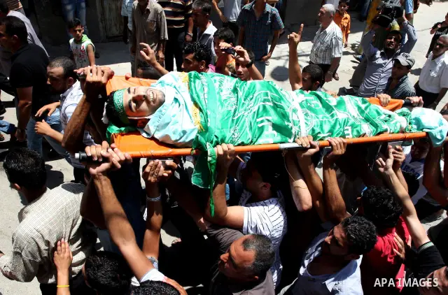 Palestinian mourners carry the body of Ibrahim Sarhan, killed by Israeli military, during his funeral in the West Bank refugee camp of El Fara, north of Nablus, Wednesday, July 13, 2011. Sarhan was killed Wednesday in an...