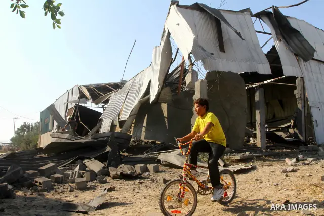 Palestinians inspect the rubble of a metal workshop after an Israeli air strike in Gaza city, early Thursday, July 14, 2011. Photo by Ashraf Amra