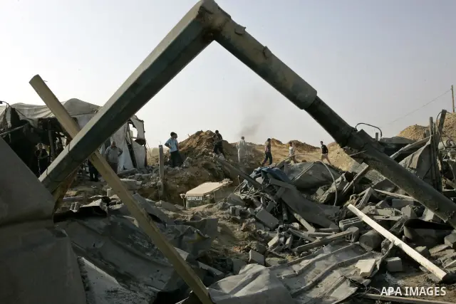 Palestinians inspect the site of a smuggling tunnel between the Gaza Strip and Egypt after it was targeted by an Israeli air strike overnight in Rafah, in the southern enclaved Palestinian territory, on July 14, 2011. Ph...