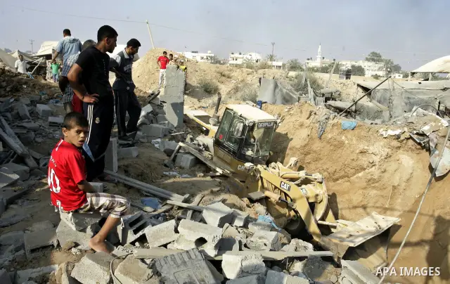 Palestinians inspect the site of a smuggling tunnel between the Gaza Strip and Egypt after it was targeted by an Israeli air strike overnight in Rafah, in the southern enclaved Palestinian territory, on July 14, 2011. Ph...