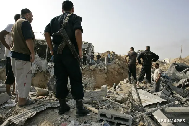 Palestinians inspect the site of a smuggling tunnel between the Gaza Strip and Egypt after it was targeted by an Israeli air strike overnight in Rafah, in the southern enclaved Palestinian territory, on July 14, 2011. Ph...