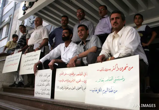 Palestinian staff hold banners in a protest in Al Makassed hospital in Jerusalem on july 14, 2011. Photo by Mahfouz Abu Turk