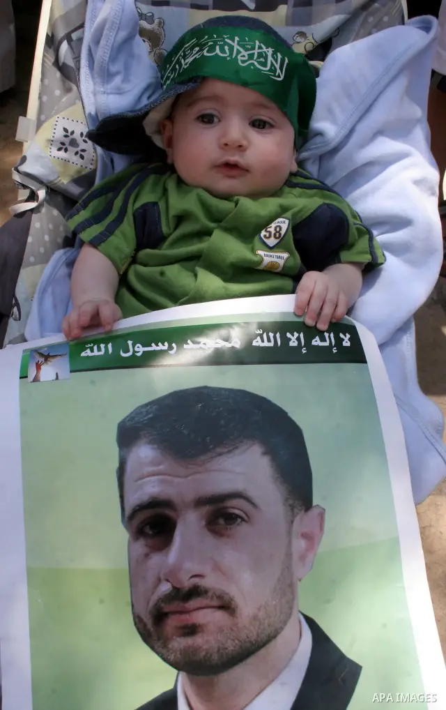 Hamas members of the Palestinian Legislative Council (PLC) take part with Palestinian supporters of the Hamas Islamist movement during a rally calling for the release of Palestinians being held in West Bank and Gaza Stri...