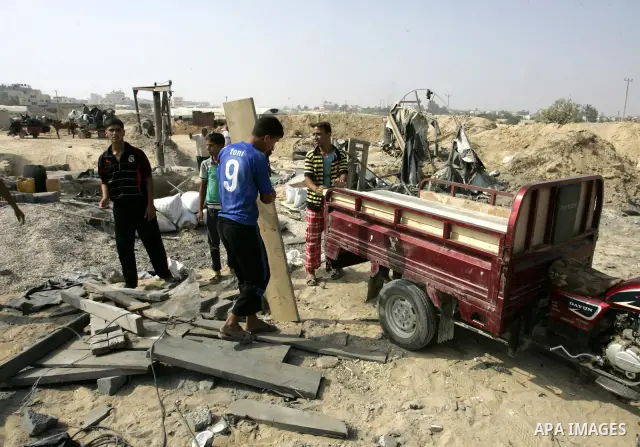 Palestinians inspect damages at a smuggling tunnel between the Gaza Strip and Egypt after it was targeted by an Israeli air strike overnight in the southern town of Rafah on July 15, 2011. Photo by Abed Rahim Khatib