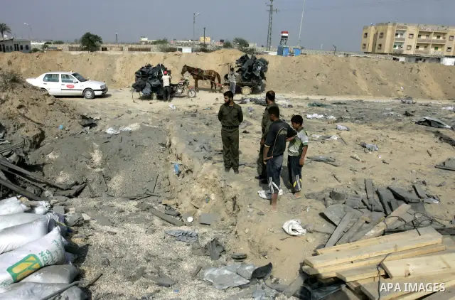 Palestinians inspect damages at a smuggling tunnel between the Gaza Strip and Egypt after it was targeted by an Israeli air strike overnight in the southern town of Rafah on July 15, 2011. Photo by Abed Rahim Khatib