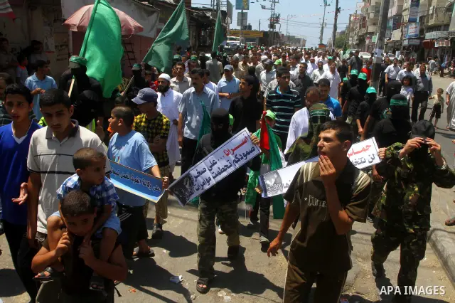 Palestinians Hamas supporters participate in a protest calling for the release of Palestinian prisoners held in Israel and against the UNESCO decision to consider Jerusalem capital of Israel, at the Nusseirat refugee cam...
