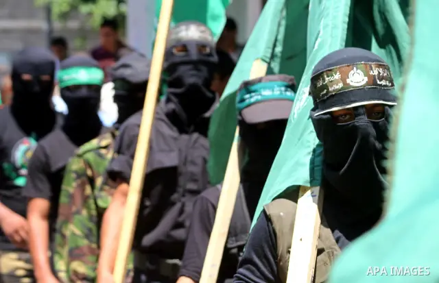 Masked Palestinians from Hamas participate in a protest calling for the release of Palestinian prisoners held in Israel and against the UNESCO decision to consider Jerusalem capital of Israel, at the Nusseirat refugee ca...