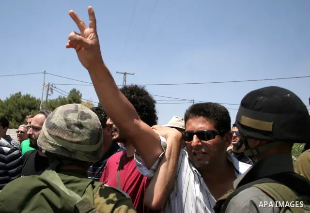 Protesters argue with an Israeli soldiers during a demonstration against Israel's controversial separation barrier in the West Bank village of Maasarah, near the biblical town of Bethlehem on 15 July 2011. Israel says th...