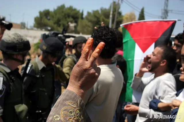 Protesters argue with an Israeli soldiers during a demonstration against Israel's controversial separation barrier in the West Bank village of Maasarah, near the biblical town of Bethlehem on 15 July 2011. Israel says th...