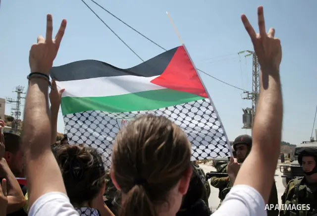 Protesters argue with an Israeli soldiers during a demonstration against Israel's controversial separation barrier in the West Bank village of Maasarah, near the biblical town of Bethlehem on 15 July 2011. Israel says th...
