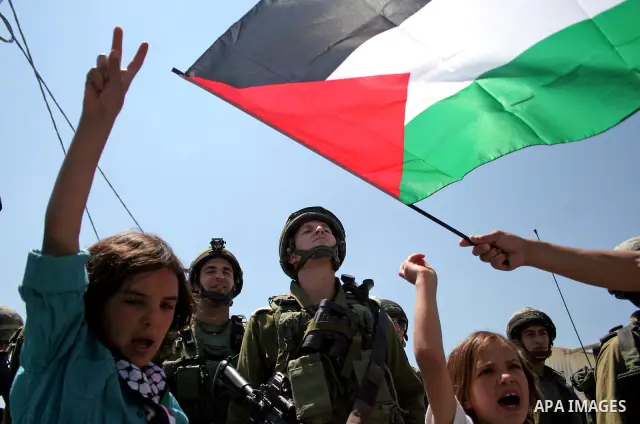 Protesters argue with an Israeli soldiers during a demonstration against Israel's controversial separation barrier in the West Bank village of Maasarah, near the biblical town of Bethlehem on 15 July 2011. Israel says th...
