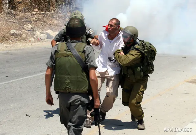 Israeli border guards arrest a Palestinian protestor during clashes following a demonstration against Israeli occupation and settlements expansion, on July 15, 2011 in the West Bank village of Nabi Saleh Photo by Issam R...