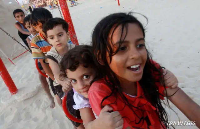 Palestinian children play in a swimming pool at a park in Gaza City on July 15, 2011. Phot by Naaman Omar