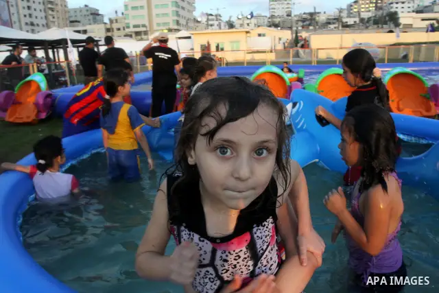 Palestinian children play in a swimming pool at a park in Gaza City on July 15, 2011. Phot by Naaman Omar
