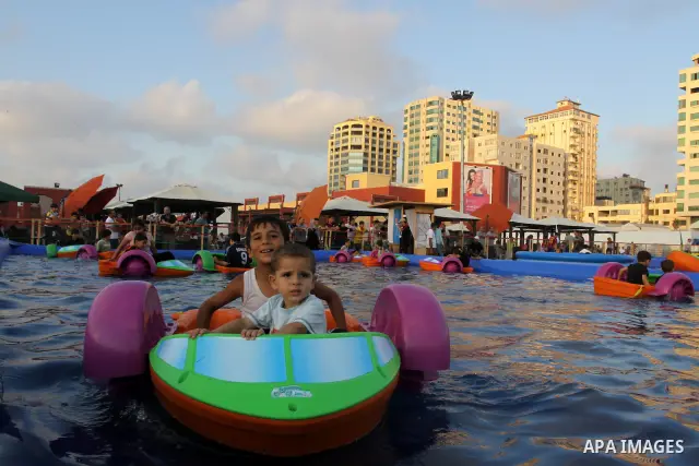 Palestinian children play in a swimming pool at a park in Gaza City on July 15, 2011. Phot by Naaman Omar