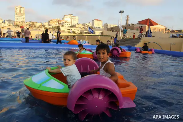 Palestinian children play in a swimming pool at a park in Gaza City on July 15, 2011. Phot by Naaman Omar
