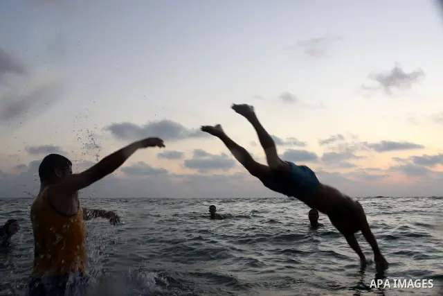 Palestinians enjoy swimming in the sea on Gaza's beach on on July 15, 2011. Reports state that during the summer the beach is a major venue for entertainment and leisure in the Gaza. Photo by Mohammed Asad