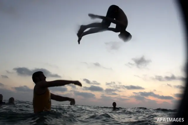 Palestinians enjoy swimming in the sea on Gaza's beach on on July 15, 2011. Reports state that during the summer the beach is a major venue for entertainment and leisure in the Gaza. Photo by Mohammed Asad