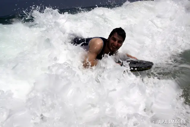 Palestinians enjoy swimming in the sea on Gaza's beach on on July 15, 2011. Reports state that during the summer the beach is a major venue for entertainment and leisure in the Gaza. Photo by Mohammed Asad