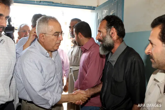 Palestinian Prime Minister, Salam Fayyad visits the family of the Martyr Ibrahim Sarhan in al-Fara'a refugee camp in the West Bank on July 16, 2011. Photo by Mustafa Abu Dayeh